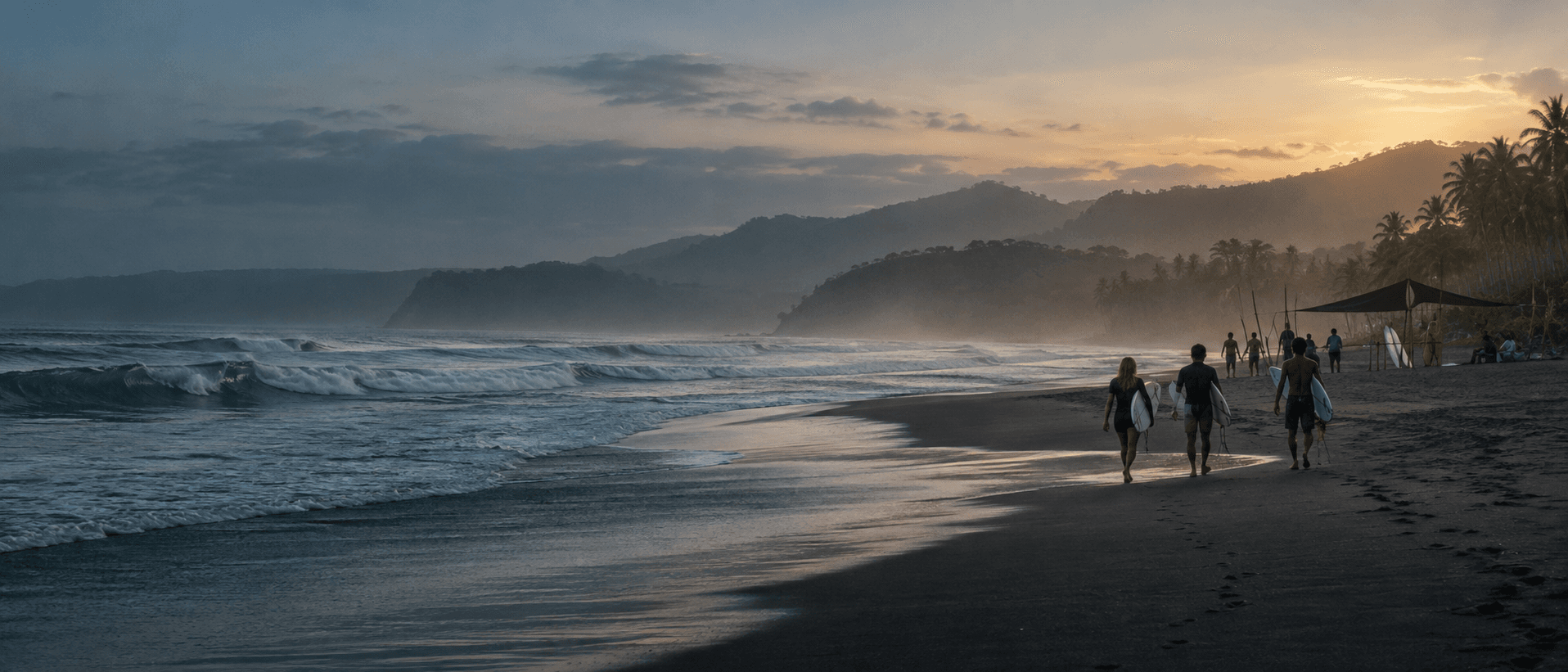 Surfers walking toward dawn waves on an Indonesian coastline