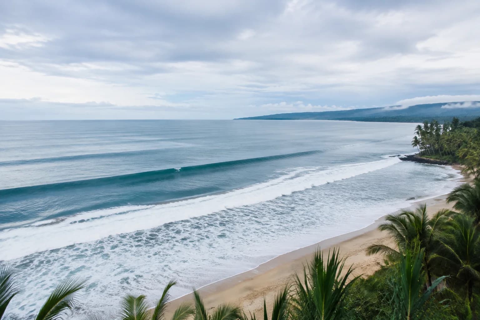 A tropical Indonesian coast under soft seasonal clouds